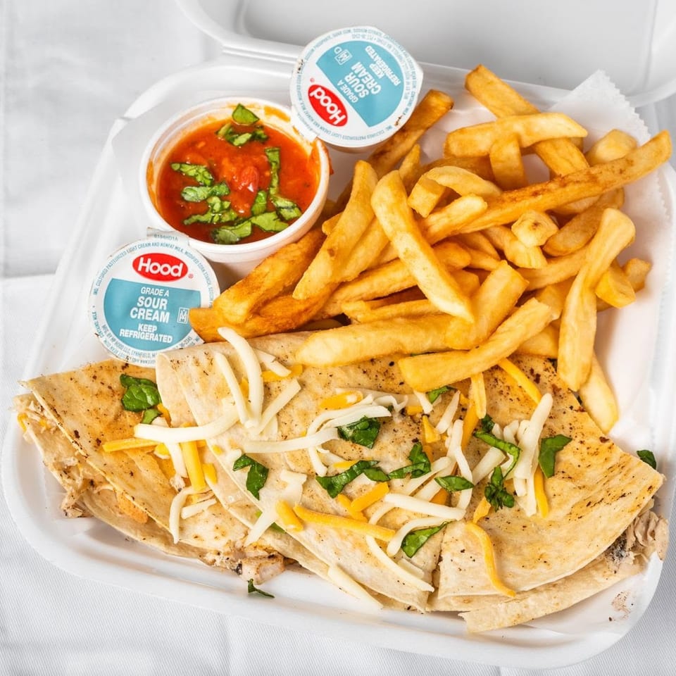 Quesadillas topped with cheese and herbs, served with french fries, salsa, and two sour cream cups.
